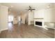 Spacious living room with an open floor plan, fireplace, and seamless flow to the kitchen and dining areas at 205 Midnight Oak Run # 5, Alpharetta, GA 30009