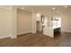 Open concept living room with wood floors adjacent to the kitchen with large island and barstool seating at 205 Midnight Oak Run # 5, Alpharetta, GA 30009