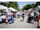 Bustling outdoor farmers market with various vendor tents and crowds at 205 Midnight Oak Run # 5, Alpharetta, GA 30009