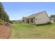 Backyard featuring a well-maintained lawn and view of houses in the distance at 419 Southland Cir, Canton, GA 30115