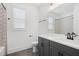 Clean bathroom with a gray vanity, quartz countertop, and a tiled shower/tub combo at 419 Southland Cir, Canton, GA 30115