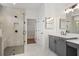 Modern bathroom with marble tile, glass shower, gray cabinets, and quartz countertops at 419 Southland Cir, Canton, GA 30115