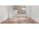 Empty bedroom with a large window letting in light and featuring hardwood floors and white trim at 419 Southland Cir, Canton, GA 30115