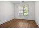Bedroom with wood floors, a large window, and white walls at 419 Southland Cir, Canton, GA 30115