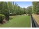 Spacious, fenced dog park area with artificial turf, benches, and shaded spots for relaxing at 419 Southland Cir, Canton, GA 30115