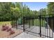 Fenced dog park area with secure gates and a sign displaying park rules, with lush greenery in the background at 419 Southland Cir, Canton, GA 30115