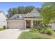 Charming single-Gathering home showcasing brick and siding facade, a well-manicured lawn, and a welcoming front porch at 419 Southland Cir, Canton, GA 30115
