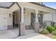 Inviting front porch with stone-based columns, black accents, outdoor seating, and manicured landscaping at 419 Southland Cir, Canton, GA 30115