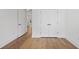 Neutral hallway with wood flooring, white walls, and double-door closet at 419 Southland Cir, Canton, GA 30115