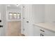 Hallway view showcasing hardwood floors, white trim, and a glimpse into a bright living space at 419 Southland Cir, Canton, GA 30115