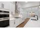 Spacious kitchen featuring stainless steel appliances, quartz countertops, and a view to the backyard at 419 Southland Cir, Canton, GA 30115