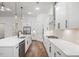 Modern kitchen with white cabinets, stainless steel appliances, hardwood floors, and an island with a sink at 419 Southland Cir, Canton, GA 30115