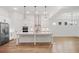 Modern kitchen with white cabinets, a large island, stainless steel appliances, hardwood floors, and open layout at 419 Southland Cir, Canton, GA 30115