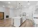 Open-concept kitchen with a large island, stainless steel appliances, and a view into the living room with fireplace at 419 Southland Cir, Canton, GA 30115