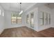 Bright living room featuring hardwood floors, a modern light fixture, and a view of the landscaped backyard at 419 Southland Cir, Canton, GA 30115