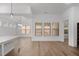 Spacious open living area featuring large windows, hardwood floors, and modern lighting at 419 Southland Cir, Canton, GA 30115