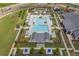 Aerial view of the community pool with cabanas, lounge chairs, and manicured landscaping and clubhouse at 419 Southland Cir, Canton, GA 30115
