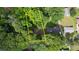 Aerial view outlines property with house and surrounding lush greenery at 50 Woodland St, Buford, GA 30518