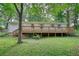 Spacious wooden deck overlooking the backyard of this cozy ranch home at 50 Woodland St, Buford, GA 30518