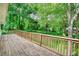View of a wooden deck overlooking a grassy backyard with mature trees at 50 Woodland St, Buford, GA 30518