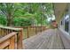 Long wooden deck overlooking a large backyard with a lush green lawn at 50 Woodland St, Buford, GA 30518