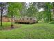 Ranch style home with a large wooden deck in a serene, tree-filled backyard at 50 Woodland St, Buford, GA 30518