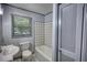 Bathroom featuring a white sink and tub, plus a window at 50 Woodland St, Buford, GA 30518