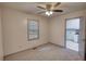 Bedroom with a ceiling fan, soft carpet, and a window providing natural light at 50 Woodland St, Buford, GA 30518