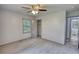 Bedroom featuring a ceiling fan, closet, and door to an ensuite bathroom at 50 Woodland St, Buford, GA 30518