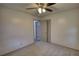 Neutral bedroom featuring a ceiling fan, closet, and neutral carpet at 50 Woodland St, Buford, GA 30518