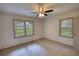 This bedroom has two windows with blinds allowing for natural light at 50 Woodland St, Buford, GA 30518