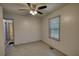 Bedroom with a ceiling fan and window providing natural light and a glimpse of the outdoors at 50 Woodland St, Buford, GA 30518