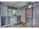 Entry room features wood-look flooring, stylish lighting, and a view of the kitchen with white cabinetry at 50 Woodland St, Buford, GA 30518
