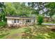 Charming single story home with manicured front lawn and mature trees at 50 Woodland St, Buford, GA 30518