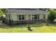 Charming single-story home with light-colored exterior, dark roof, and well-maintained front lawn at 50 Woodland St, Buford, GA 30518