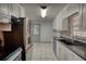 The bright kitchen features white tiled floors, stainless appliances, and plenty of counter space at 50 Woodland St, Buford, GA 30518