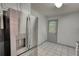 Bright kitchen with stainless steel refrigerator and a door leading to the outside deck at 50 Woodland St, Buford, GA 30518