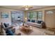 Bright, staged living room featuring hardwood floors, modern decor, and large windows at 50 Woodland St, Buford, GA 30518