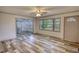 Bright living room features neutral walls, wood-look flooring and ample natural light from a large window at 50 Woodland St, Buford, GA 30518