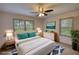 Staged main bedroom features plush bedding, stylish decor, and ample natural light at 50 Woodland St, Buford, GA 30518