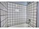 Shower with white square tile and dark grout at 50 Woodland St, Buford, GA 30518