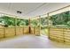 Comfortable covered porch with natural wood details and views of the wooded backyard at 120 Ingleside Dr, Jonesboro, GA 30236