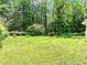 Large grassy backyard with mature trees at 120 Ingleside Dr, Jonesboro, GA 30236