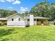 Spacious backyard showcasing the house with its brick foundation and a covered porch at 120 Ingleside Dr, Jonesboro, GA 30236