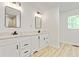 Bathroom featuring double sink vanity with modern fixtures, mirrors, and bright natural light at 120 Ingleside Dr, Jonesboro, GA 30236