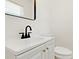 Bathroom featuring single sink vanity with modern fixtures and white cabinets at 120 Ingleside Dr, Jonesboro, GA 30236