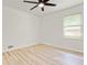 A bright bedroom features light wood floors, recessed lights, and one window at 120 Ingleside Dr, Jonesboro, GA 30236