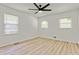 A bright bedroom features light wood floors, recessed lights, and two windows at 120 Ingleside Dr, Jonesboro, GA 30236