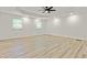 A bright bedroom features light wood floors, recessed lights, and a modern ceiling fan at 120 Ingleside Dr, Jonesboro, GA 30236