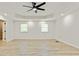 A bright bedroom features light wood floors, recessed lights, and a modern ceiling fan at 120 Ingleside Dr, Jonesboro, GA 30236
